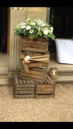 some wooden crates with flowers in them on the ground