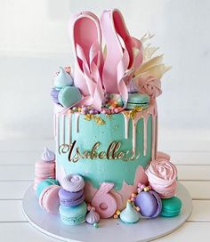 there is a cake decorated with pink and blue icing on the top, along with lots of other decorations