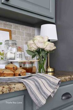 a kitchen counter with flowers and cookies on it