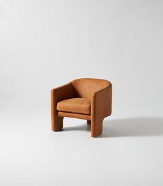 a brown chair sitting on top of a white floor