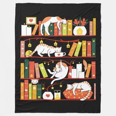 a black blanket with cats and books on it