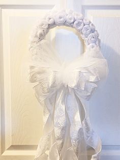 a white wreath is hanging on the door