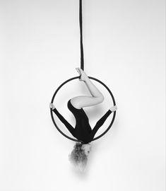 a woman hanging upside down on a hoop