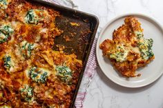 a casserole dish with spinach and cheese on it next to a plate