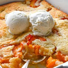 a close up of a dish of food with ice cream on top and spoon in it