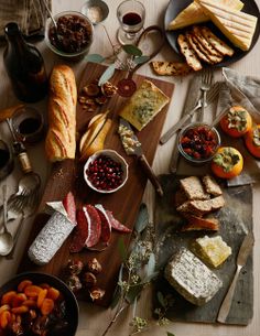 a table filled with bread, meats and vegetables