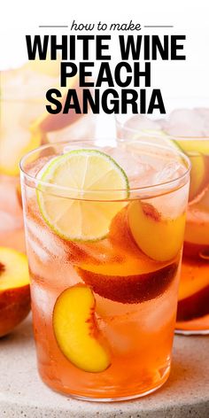 white wine peach sangria with sliced lemons and lime on the rocks in front