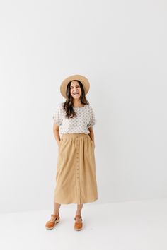 Start your day in style with the 'Greta' Skirt! This midi length, linen-blend skirt is light and airy for spring and summer and features button-down detailing for a fun touch. Pair the 'Greta' with all your favorite tops for Sunday morning or a day at the farmer's market! 30% Linen 70% Rayon Hand Wash Cold Hang to Dry Low Iron if Needed Do Not Dry Clean Fully Lined Model in Ochre Height 5'5" | Wearing Size Small Wearing 'Shalom' Geometric Print Top in Tan & 'Greta' Linen Blend Midi Skirt in Ochr Relaxed Summer Maxi Skirt For Day Out, Summer Relaxed Maxi Skirt For Day Out, Lightweight Maxi Skirt For Spring Day Out, Modest Relaxed Fit Bottoms For Spring, Spring Day Out Maxi Skirt, Spring Midi Bottoms With Button Closure, Spring Vacation Button-up Bottoms, Buttoned Maxi Skirt For Spring, Summer Daywear Maxi Skirt With Lining