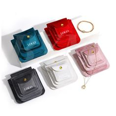 four different colored purses sitting next to each other on a white surface with the word logo printed on them