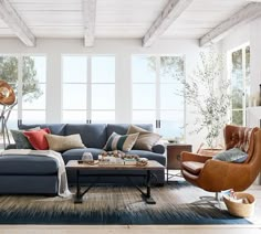 a living room filled with furniture and lots of windows