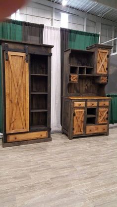 two large wooden cabinets sitting next to each other on top of a hard wood floor