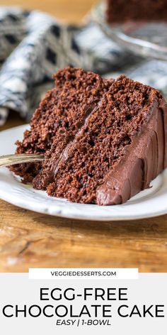 a slice of chocolate cake on a white plate with the words egg - free chocolate cake