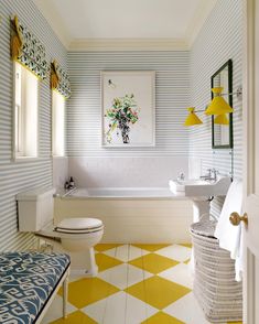 a bathroom with yellow and white tiles on the floor, sink, toilet and bathtub