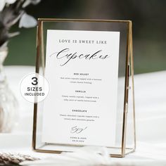 a table with a menu card and vase filled with flowers on it, along with the words love is sweet like cupcakes written in curs