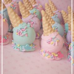 there are many small cakes with ice cream and sprinkles on them in the shape of unicorn's heads