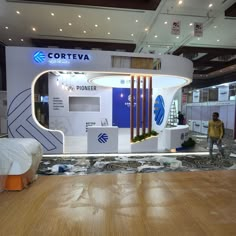 a man is standing in front of a trade show booth that has been set up