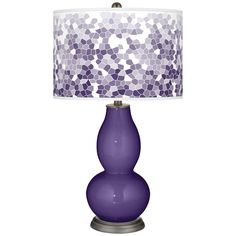 a purple table lamp with a white shade on the top and small circles around it