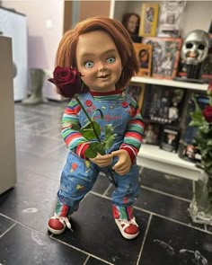 a creepy doll holding a rose in her hand and looking at the camera while standing on a tiled floor