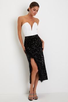 The Lulus Luminous Aura Black Sequin Feather High-Rise Tulip Midi Skirt is perfect for taking any party-ready look to the next level! This ultra-luxe velvet skirt is adorned with dazzling black sequins throughout as it shapes a high-rise fit and a pencil-style, overlapping silhouette that creates a faux-wrap effect as it falls to a modern midi hem. Fluffy feather trim accents the overlapping panel to lend an extra touch of glam! Hidden side zipper/clasp. Fit: This garment fits true to size. Leng Glamorous Fitted Long Skirt, Glamorous Gala Skirt, Glamorous Asymmetrical Skirt For Cocktail Events, Glamorous Asymmetrical Skirt For Cocktail, High Waist Party Dress With Lined Skirt, Glamorous Asymmetrical Skirt For Evening, High Waist Dresses With Lined Skirt For Party, Glamorous High Waist Evening Skirt, Fitted Glamorous Asymmetrical Skirt