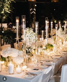 a long table is set with candles and flowers for a formal dinner or wedding reception