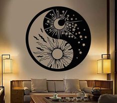 a living room filled with furniture and a yin sign wall decal on the wall