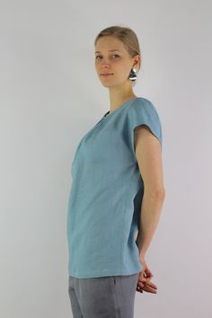 "Handmade turquoise linen blouse with short sleeves, perfect for casual wear and suitable for any occasion in any season Details: - 100% natural linen produced in Europe ; - medium weight (180 gram per square meter); - color: turquoise, can be any from our colors catalog (color samples at the photo); Made to order, approximately a few days, If you have any questions please message me and I will be glad to answer. Size guide : Size XS Bust: fits bust around 33\"-34\"/ 84-88 cm Waist: fits waist a Blue Linen V-neck Blouse, Light Blue Linen Short Sleeve Top, Blue Short Sleeve Linen Dress For Summer, Light Blue Relaxed Fit Linen Tops, Relaxed Fit Light Blue Linen Tops, Light Blue Short Sleeve Blouse For Beach, Turquoise Short Sleeve Tops For Spring, Blue Linen Short Sleeve Top, Turquoise Short Sleeve Top For Summer