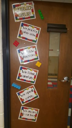 a door decorated with stickers and magnets that read, we teach our children