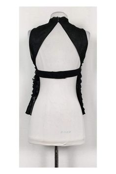 Sexy tank top from Robert Rodriguez. Made in a lightweight silk with a ruffled fabric and a rhinestone trim at the front. A flirty exposed back tops off the look. Size 2 100% silk Ruffled fabric Open back Rhinestone detail on front Tie w/ snap button closure on back Semi-sheer Unlined Raw edge along neckline and hem Bust 31" Waist 30" Shoulder to hem 22" Ruffle Fabric, Robert Rodriguez, Ruffle Tank Top, Rhinestone Trim, Black Silk, Raw Edge, Snap Button, Open Back, Halter Dress