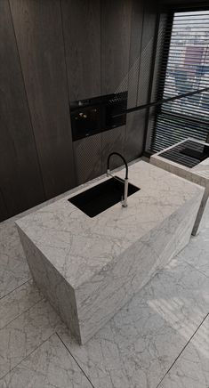 a white marble counter top sitting next to a window