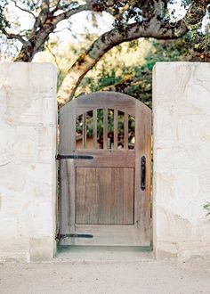 an old wooden gate is open to the outside