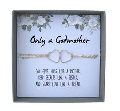 two heart bracelets in a box with the words only a godmoter on it