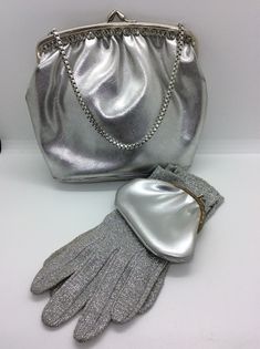 Vintage silver evening bag and purse with  vintage silver  Evening gloves. What a great set these are ! Let the party begin .. Silver bag with silver chain handle, there is a matching purse  , twist open clasp , inside silky lining , very clean on inside . still has little vanity mirror wrapped in the pocket .  vintage silver glittery gloves,lovely pair of gloves ,look great on , size 6-7 Both bag and gloves are in great vintage condition. Please view all pictures for more detail. Any questions please ask. Please take a look at my other wonderful vintage accessories and vintage treasures available in my shop. I am regularly adding new items so please favourite my shop to stay updated. Thanks for looking!🐝 Happy to combine postage 📦 Evening Gloves, Silver Bags, Vintage Party, Manicure Set, Vintage Scarf, Stunning Necklace, Vintage Accessories, Clutch Handbag, Vintage Silver