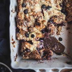 a close up of a plate of food with blueberries and lemons on it