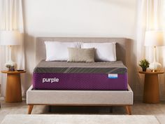 the purple mattress is on display in front of two nightstands and a table with lamps