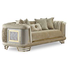 a beige couch with pillows on it and some gold trim around the armrests