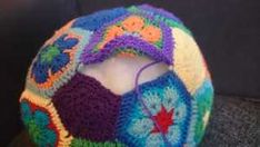 a multicolored crocheted hat on top of a table