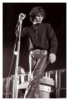 a man standing next to a microphone on top of a stage