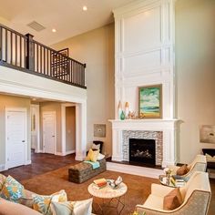 a living room filled with furniture and a fire place in the middle of a room