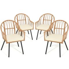 four rattan chairs with black legs and white cushions, all in different shapes and sizes