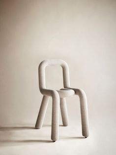 a white chair sitting in the middle of a room