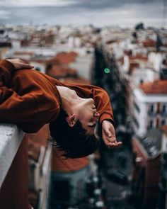 a woman standing on top of a tall building