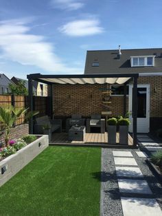 an outdoor living area with grass and plants