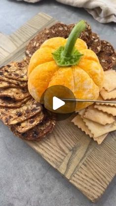 a plate with crackers, oranges and other food items on top of it