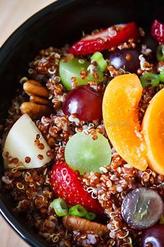 a bowl filled with fruit and nuts on top of a table