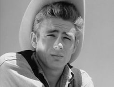 a black and white photo of a man wearing a cowboy hat with his eyes closed