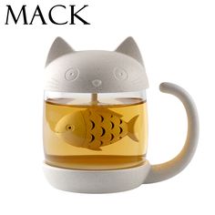 a tea cup with a cat and fish in the top, on a white background