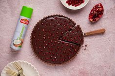 a chocolate tart topped with pomegranate next to a can of nutella