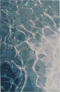 a blue and white rug with water ripples on it