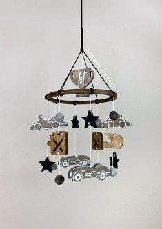 a mobile with cars and stars hanging from it