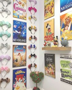 there are many posters on the wall with mickey mouse heads and other disney related items